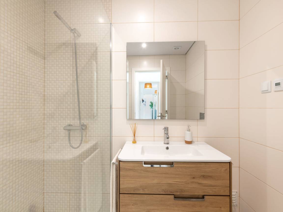 Salle d'eau avec douche et meuble vasque en bois